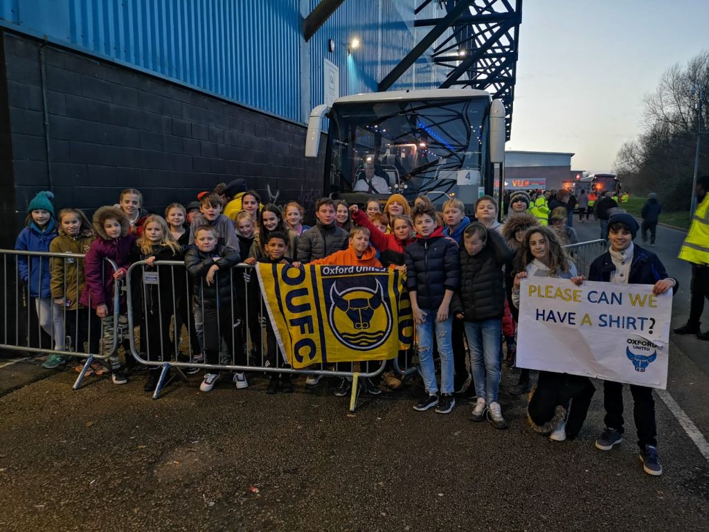Students outside the Kassam Stadium with banners