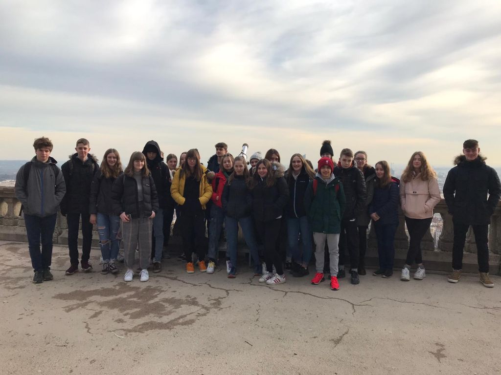 Students in front of a panomaric view of the city