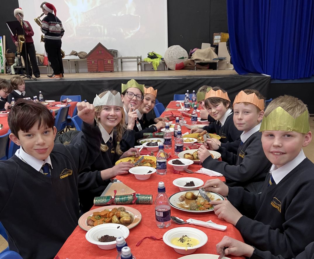 Students at a long table with their Christmas lunch
