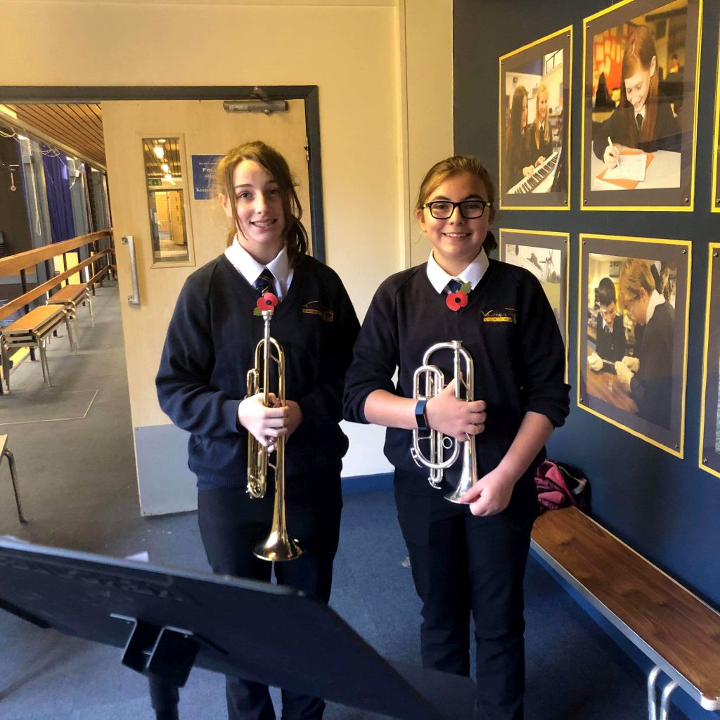 Two students prepare to play The Last Post