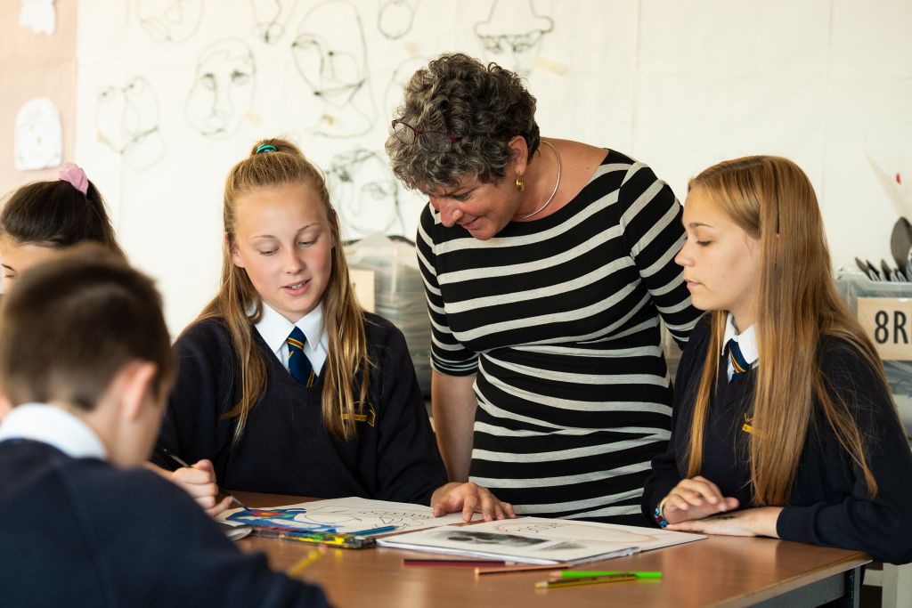 Teacher listening to students