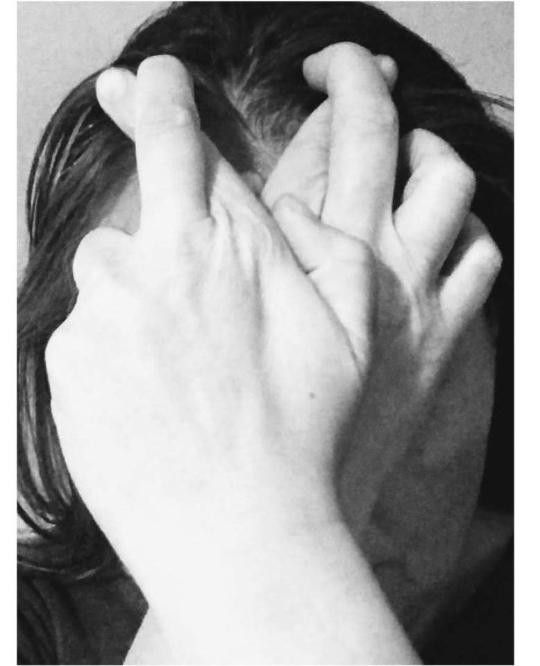 Jamila - "Fingers Crossed" - Junior Winner - person's face hidden by both hands with fingers crossed