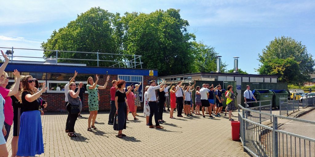 Staff wave off the students.