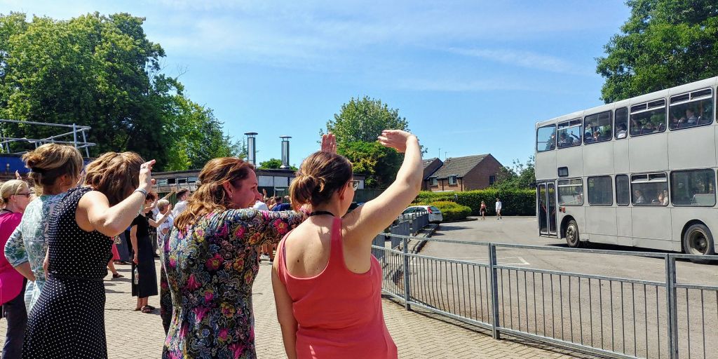 Staff wave off the students.