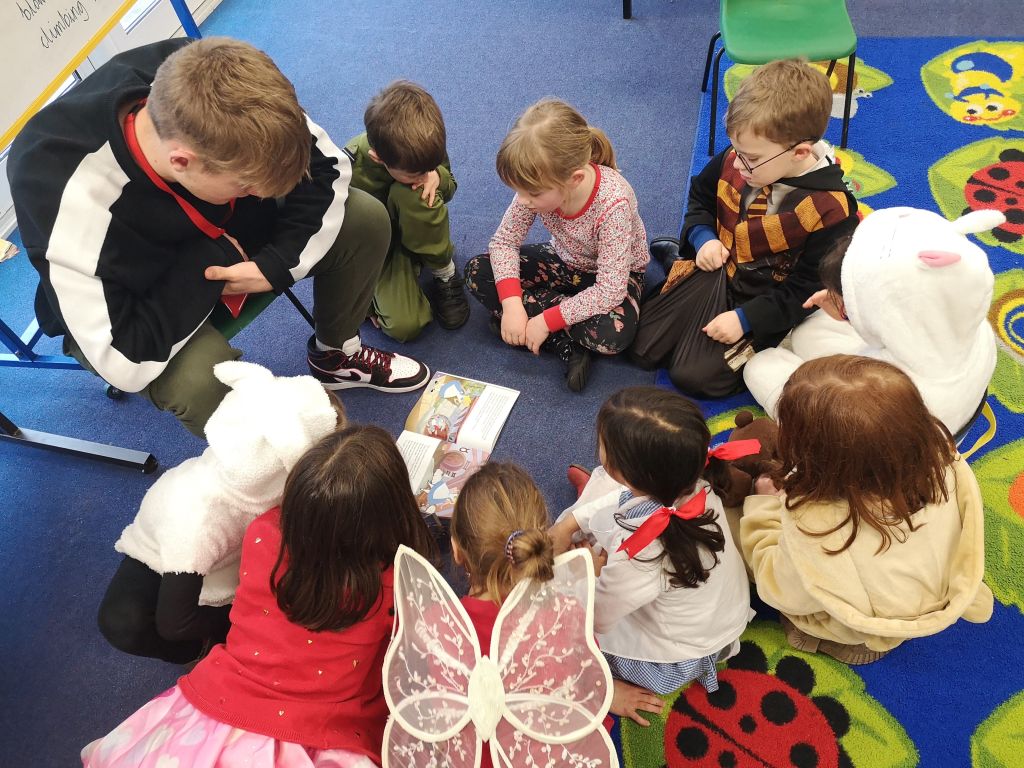 Boy reading to Brightwell students